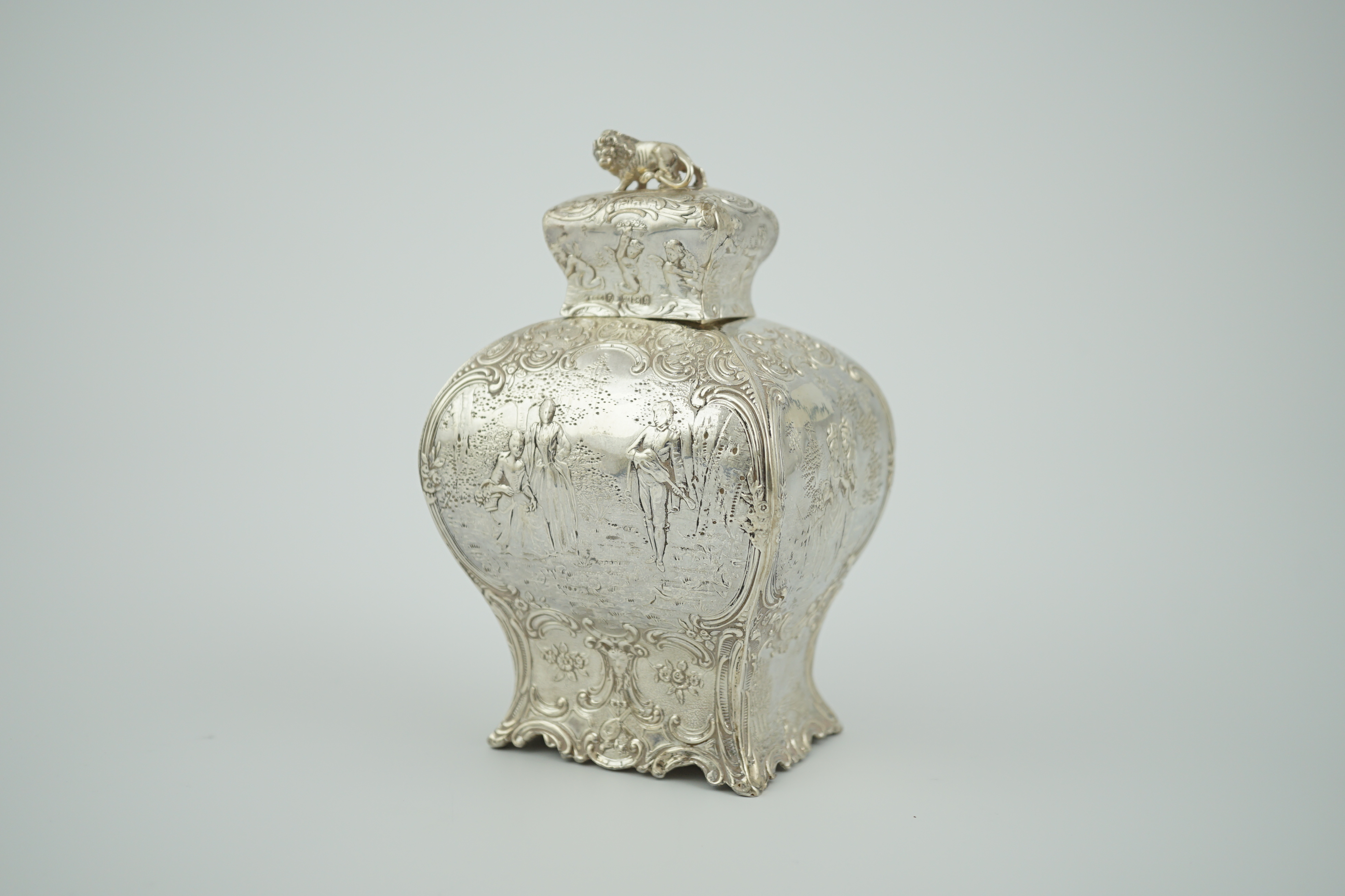 A late 19th century Hanau embossed silver bombé shaped tea caddy and cover